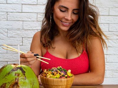 woman eating salad on table