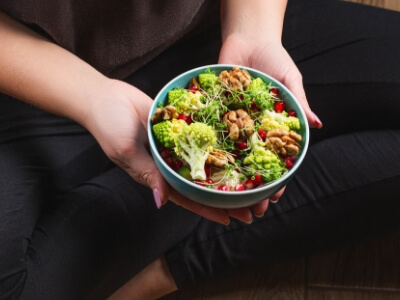 woman holding a bowl of salad diet